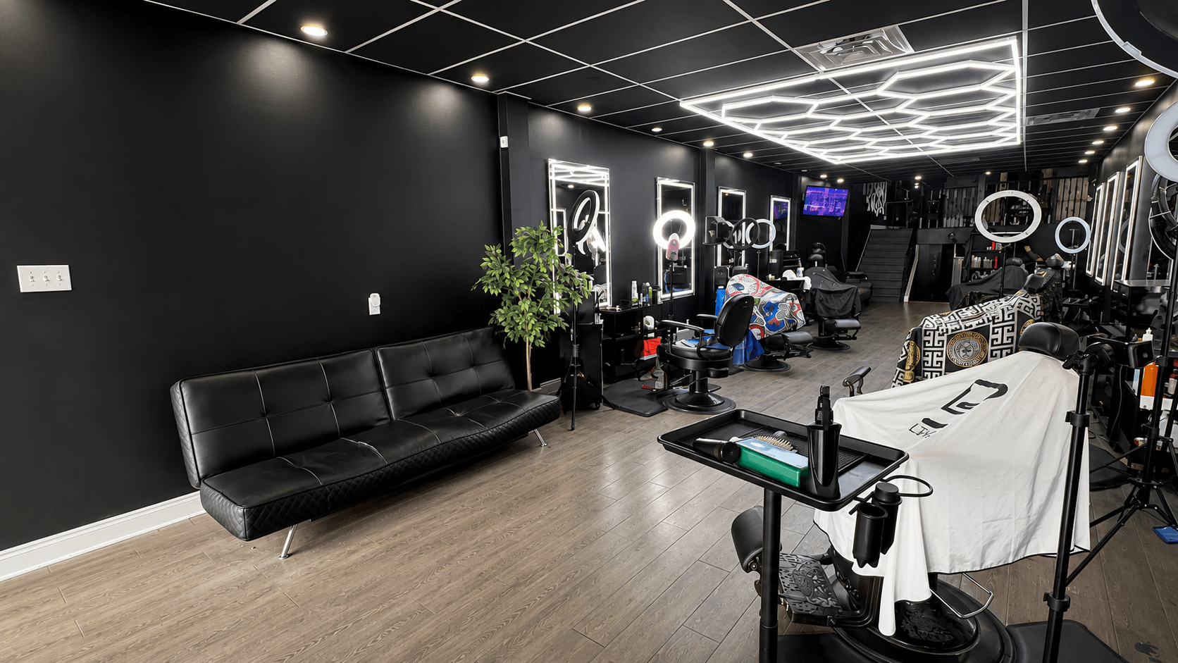Top5 Studio event space — open lounge and barber floor with warm lighting.